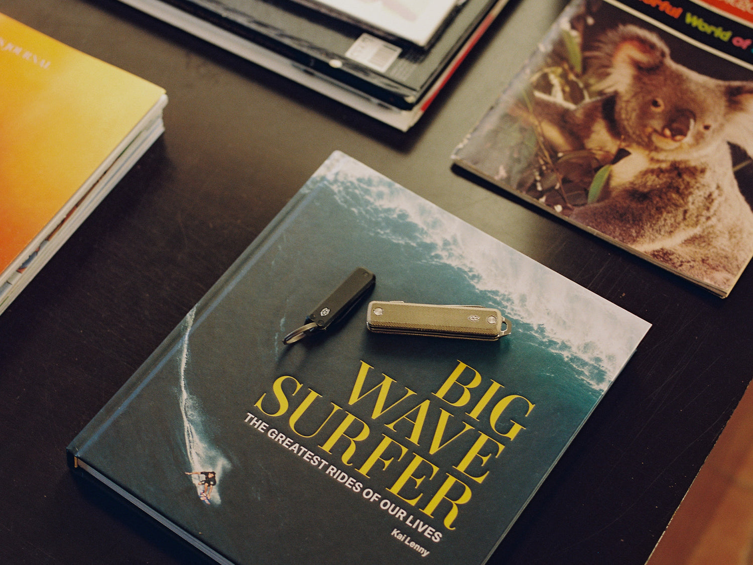 The Ellis and the Elko pocket tools on a book.