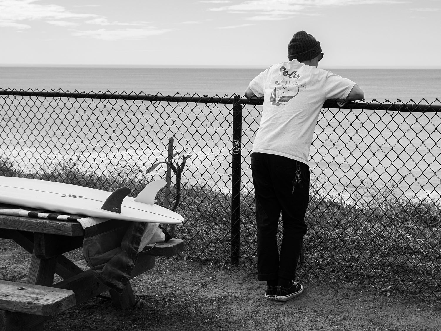 Professional skateboarder and surfboard shaper, Zak Miller, checking the waves in Carlsbad, California.