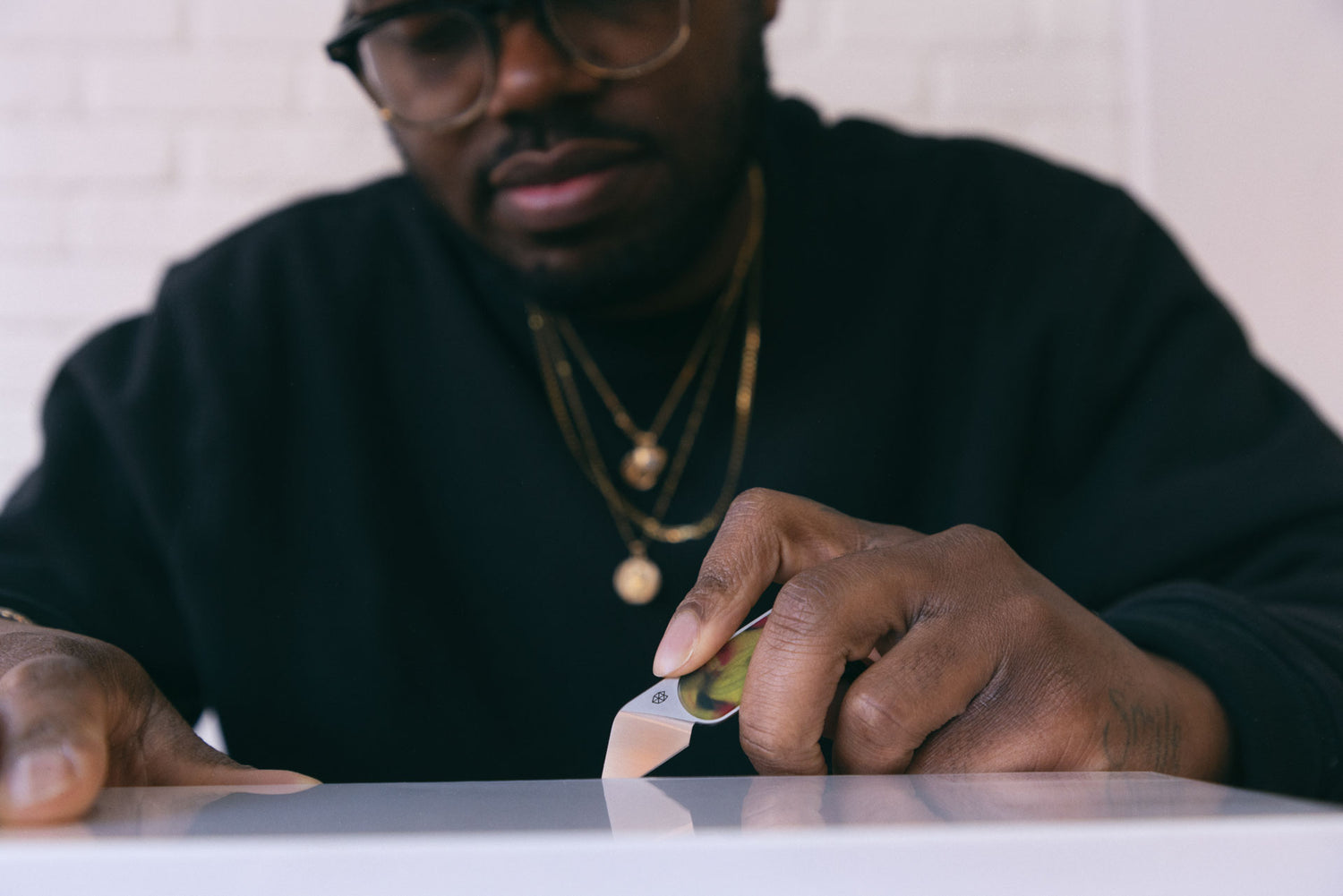 A man opening a package with the Abbey everyday mini fixed blade knife.