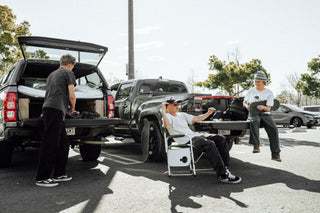 A group of skateboarders hanging out in a parking lot.