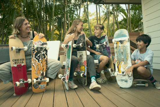 A group of kids with skateboards they are donating for Giving Tuesday.
