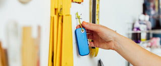 A woman reaching for the Palmer utility box cutter on a nail.