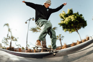 A skateboarder grinding a curb.