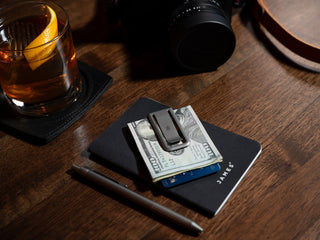 The Martindale titanium money clip on a notebook.