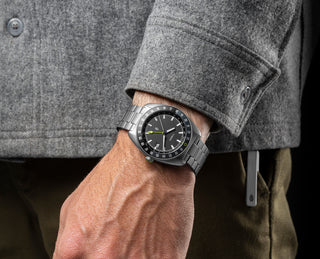 The watch in the Timex × The James Brand Automatic GMT box set on a wrist.