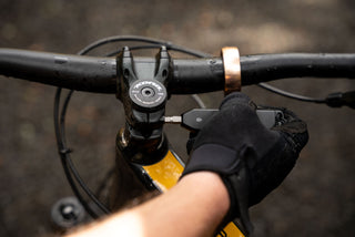 A mountain biker tightening his handlebars with The Warrick EDC screwdriver.