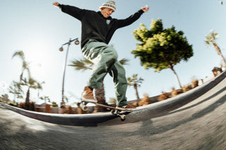 A skateboard grinding on a curb.