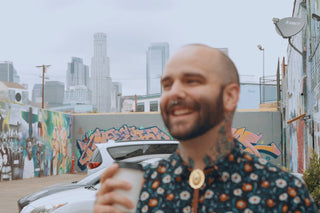 Death & Co bartender, Jack Stevenson having a coffee with the LA skyline behind him.