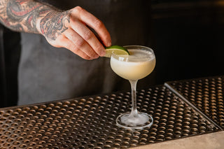 A Death & Co bartender preparing a drink.