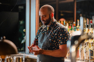 A bartender creating a craft cocktail.