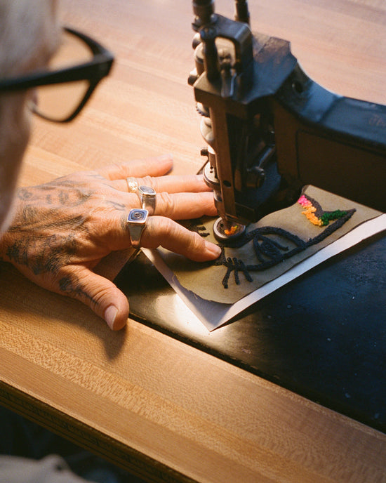 Mark Oblow stitching a patch.