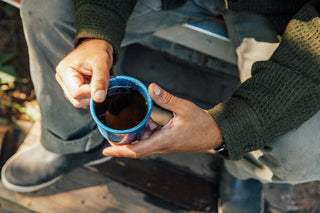 A man holding his coffee.