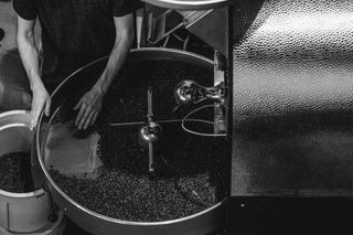A man roasting a batch of coffee.