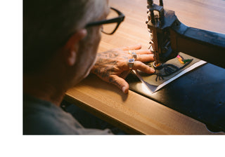 Mark Oblow chain stitching a patch.