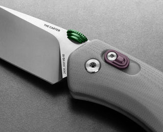 The slide lock and pivot of The Carter EDC pocket knife in primer gray and stainless.