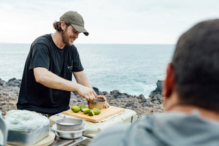 Chef Connor Gabbot preparing ceviche on an ocean side cliff.