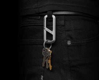 The Madison keychain carabiner in titanium clipped to a belt loop with keys.