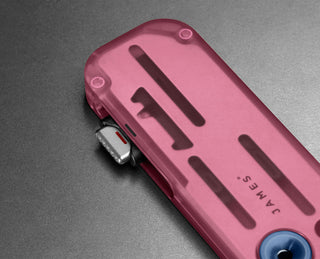 The opening mechanism of the Palmer Clear utility box cutter in Mulberry and Deep Blue.