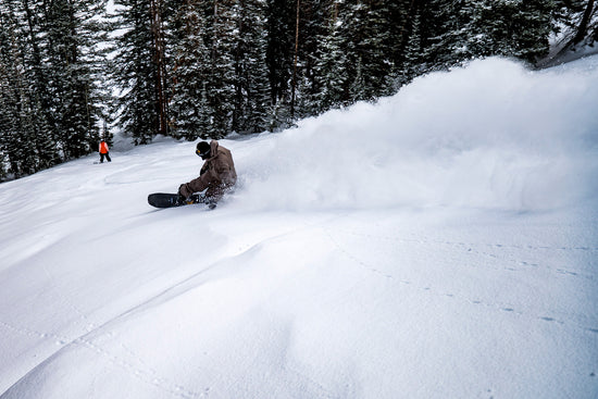 Professional snowboarder Jill Perkins carving through powder